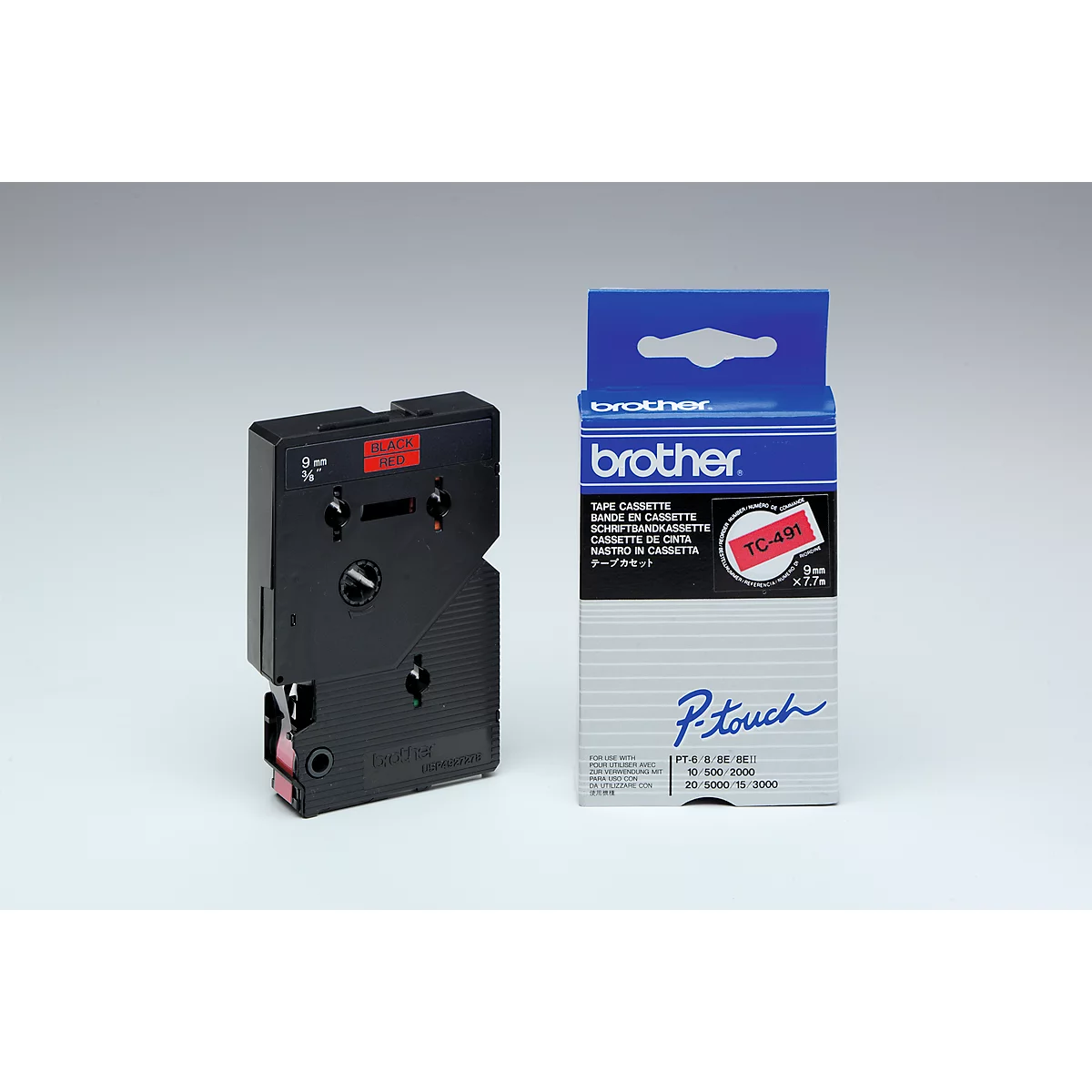 A black label cassette and a blue cardboard package with print. A red stripe is visible on the cassette, the package has a white background and is printed with the "brother" logo.