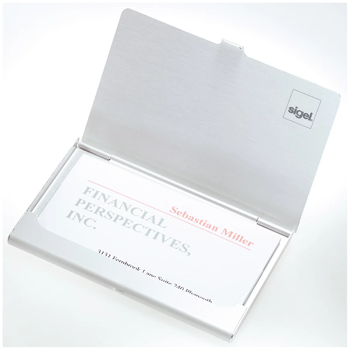 Silver business card holder with the lid open. The cards say: Financial Perspectives, Inc.