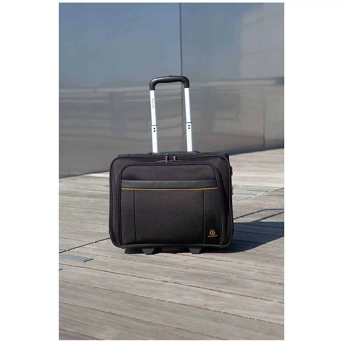 Black trolley with yellow accents. Extendable handle, wheels, stands on wooden planks.