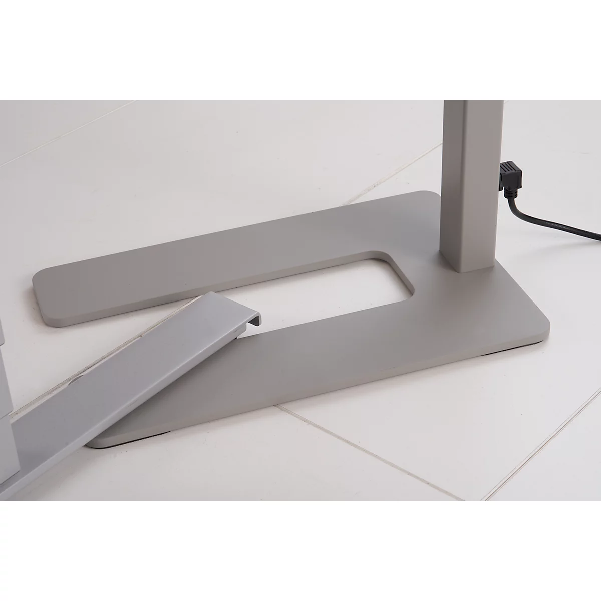 Close-up of the silver base of a standing table with a protruding detail.