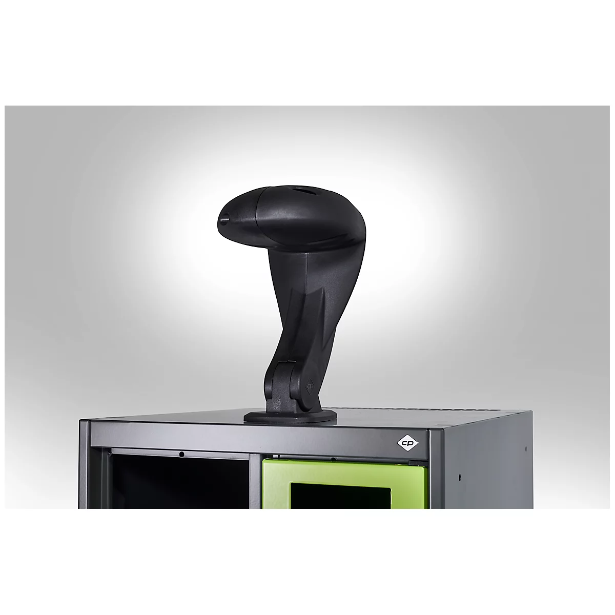 Black, snake-shaped device on a cabinet. Head points left, background is gray.