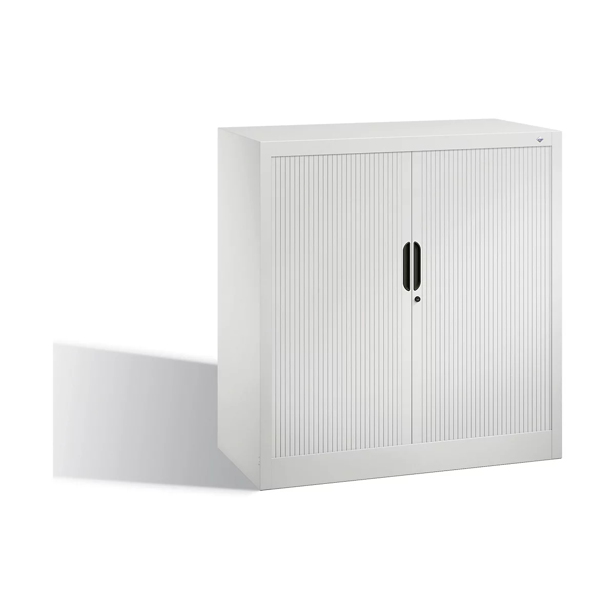 White filing cabinet with ribbed doors, black handle, and shadow.