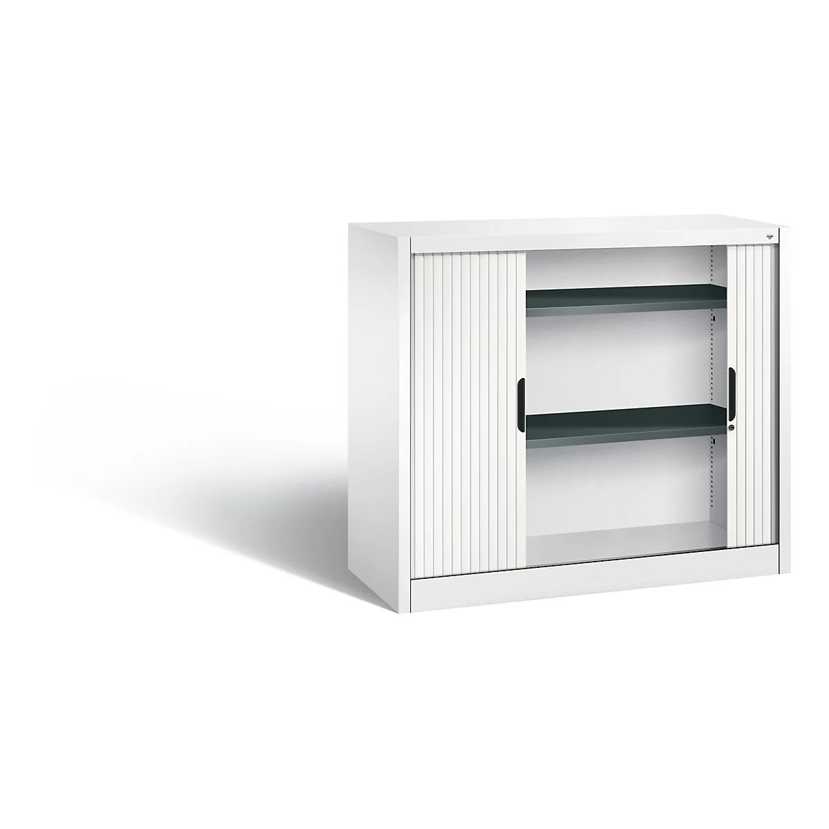White cabinet with two shelves and roller shutter. Black handles and gray shelves, shadow.