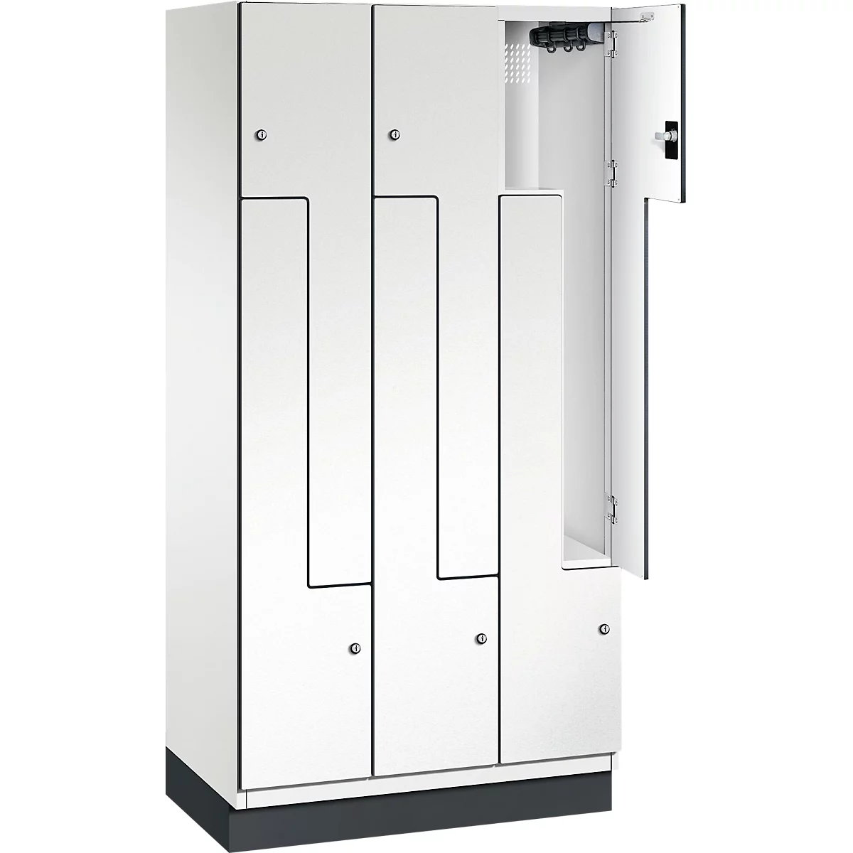Weißer Schrank mit geöffneter Tür. Einzelne Fächer mit schwarzer Umrandung, silberfarbene Knöpfe.