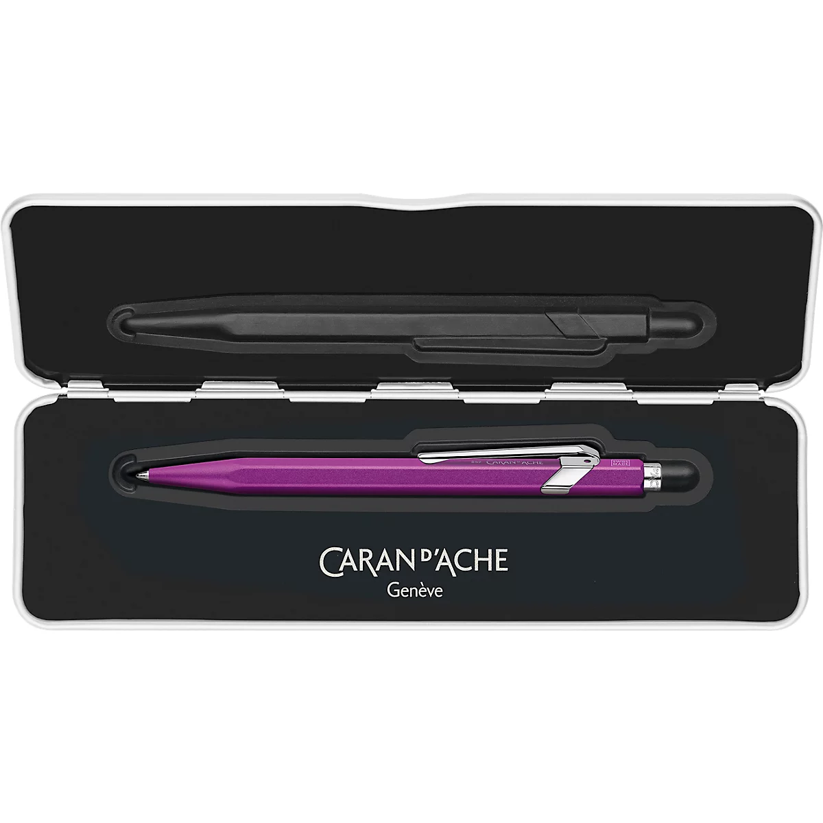 Pens in an open white box: black on top, pink below. Text "CARAN D'ACHE Geneve".