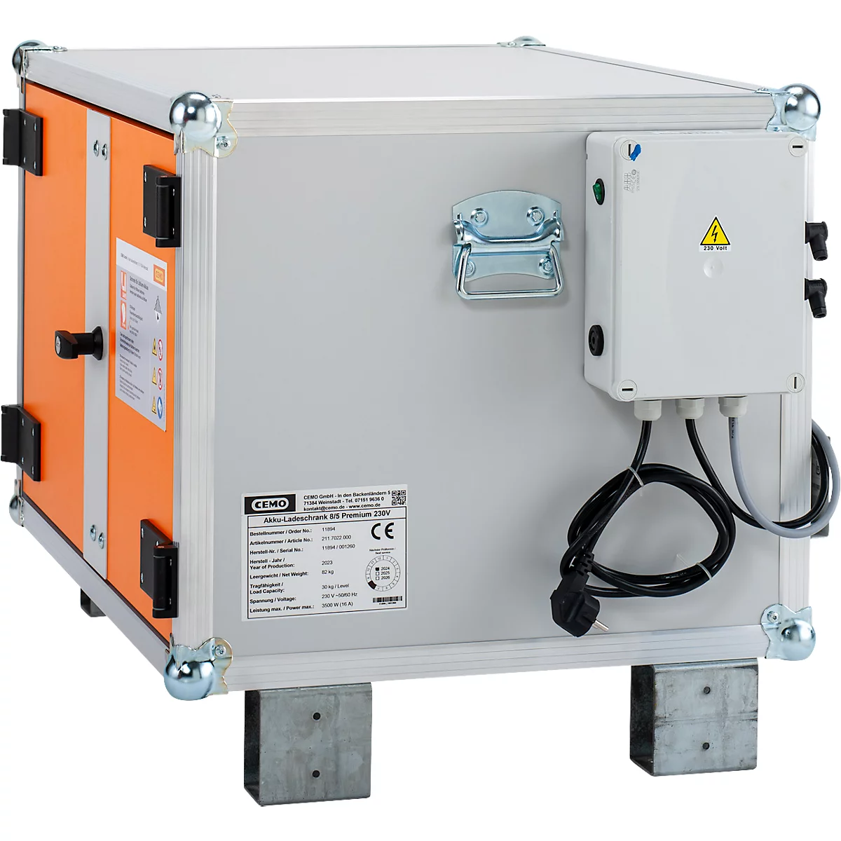 Grauer Koffer mit orangen Seiten, Metallkanten und einem weissen Schaltkasten. Aufkleber, CE-Zeichen und Warnhinweis vorhanden.