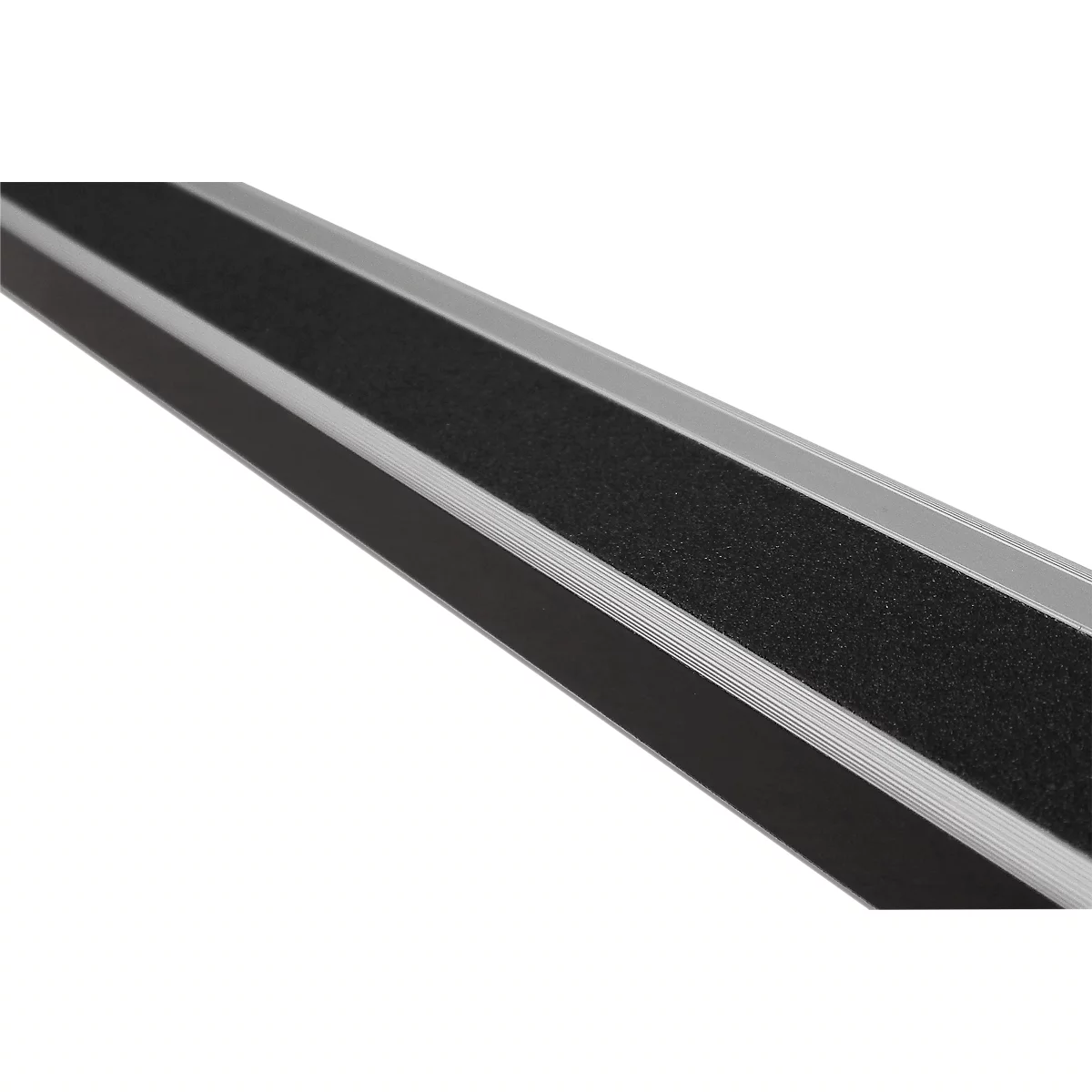 Detailed close-up of a silver ramp with a black, textured surface. The parallel grooves are clearly visible.