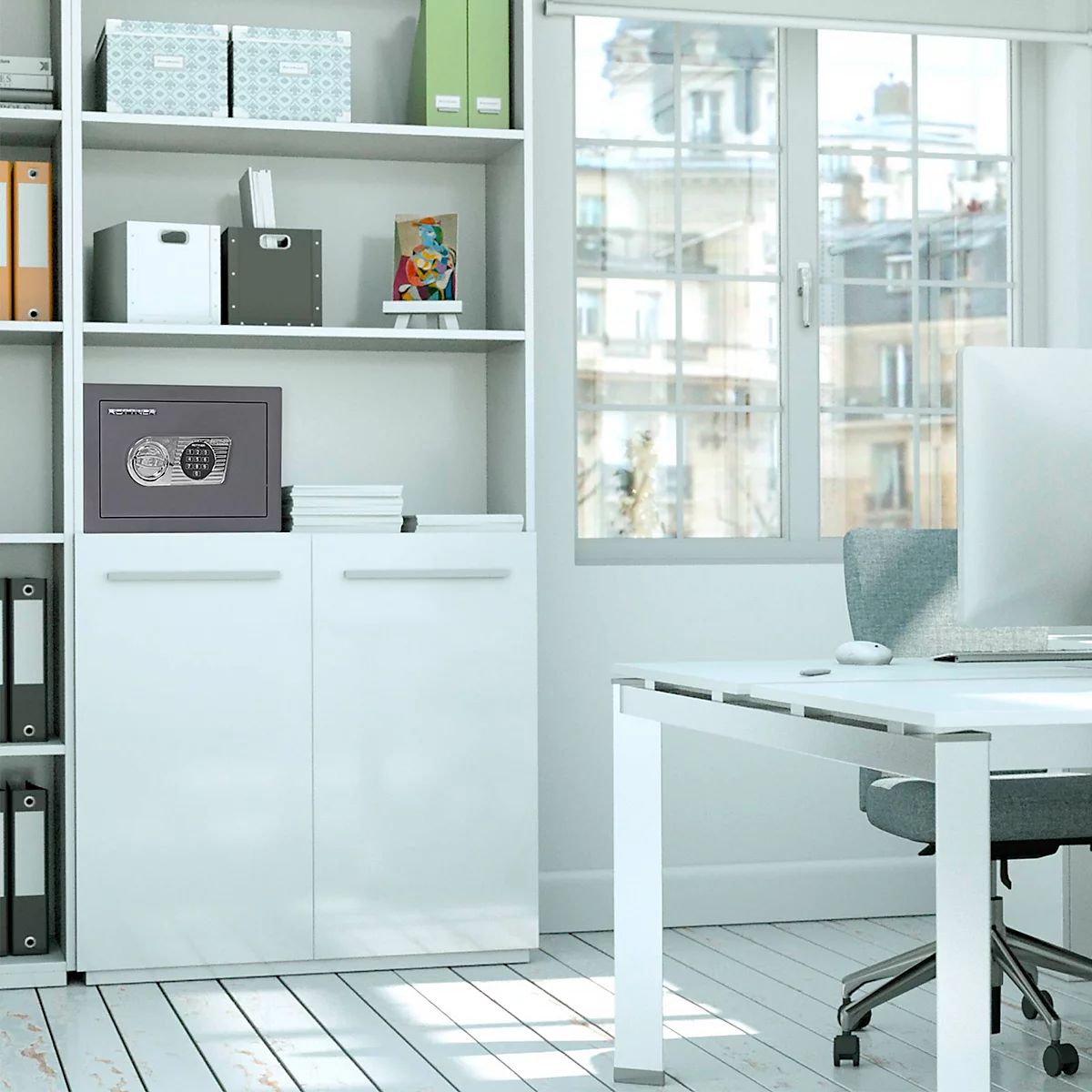 Un coffre-fort gris dans un bureau blanc, placé sur une armoire à côté d'une fenêtre.