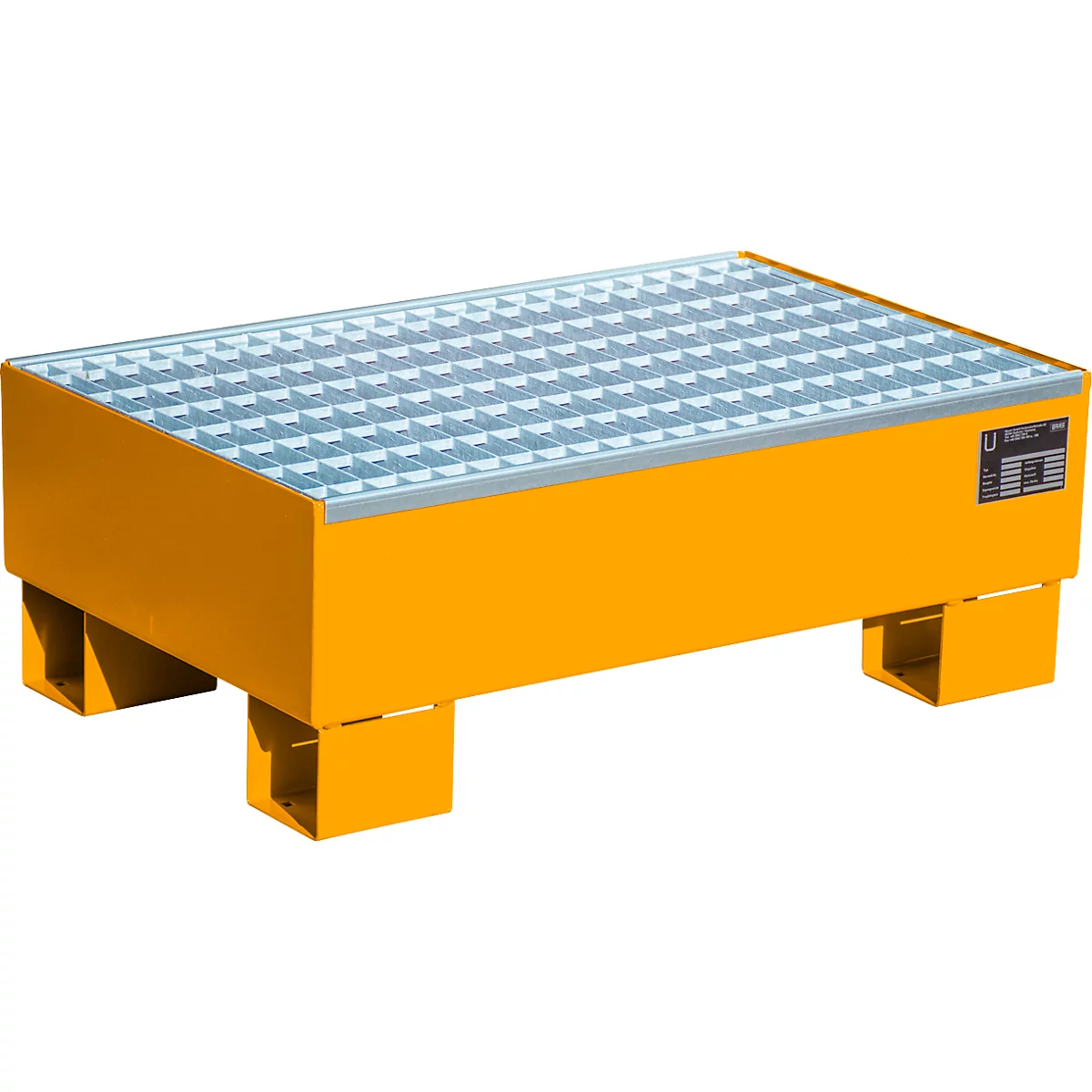 Yellow oil sump with grating. Standing on four feet.