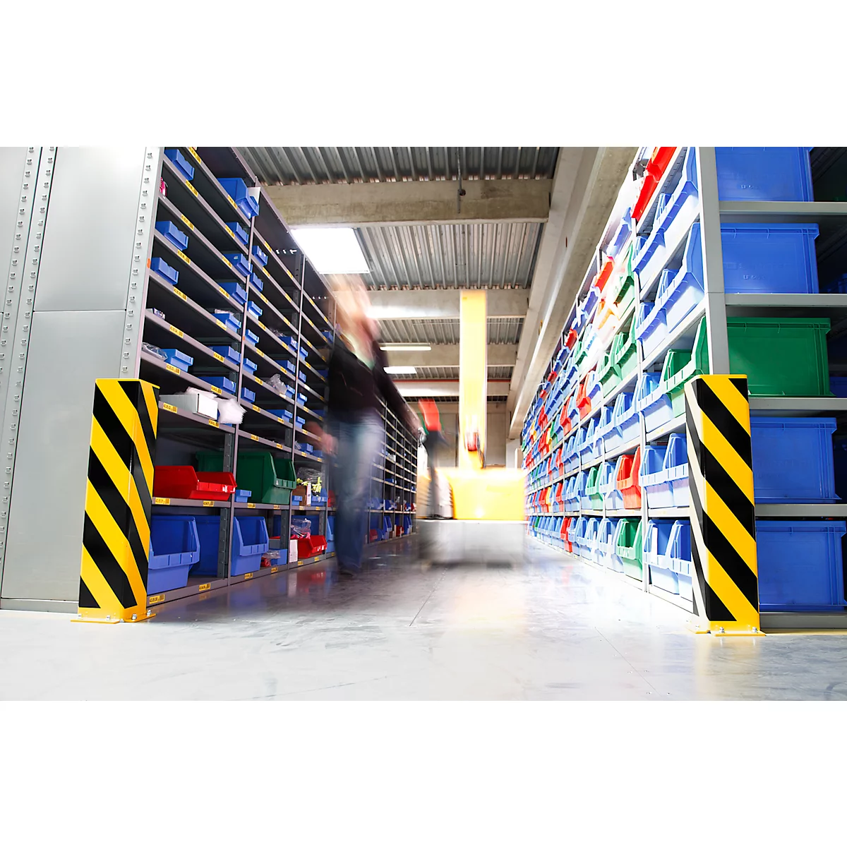 Warehouse with shelves and boxes, blurred person in the aisle.