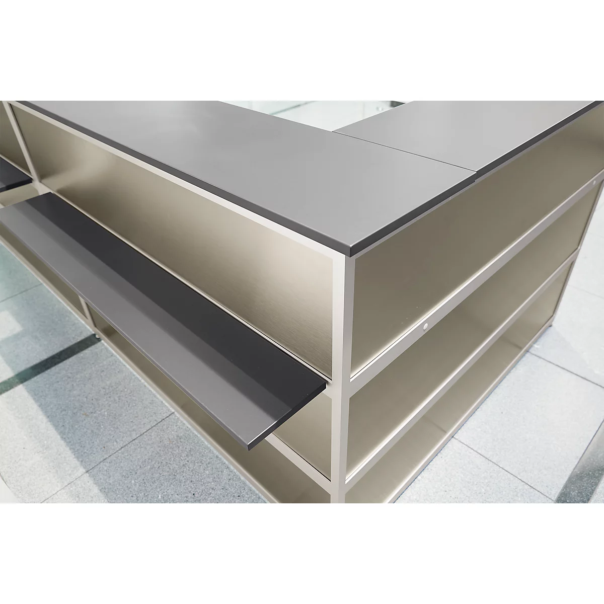 Detailed shot of a modern gray counter with shelf and shelves. The edges are rounded.