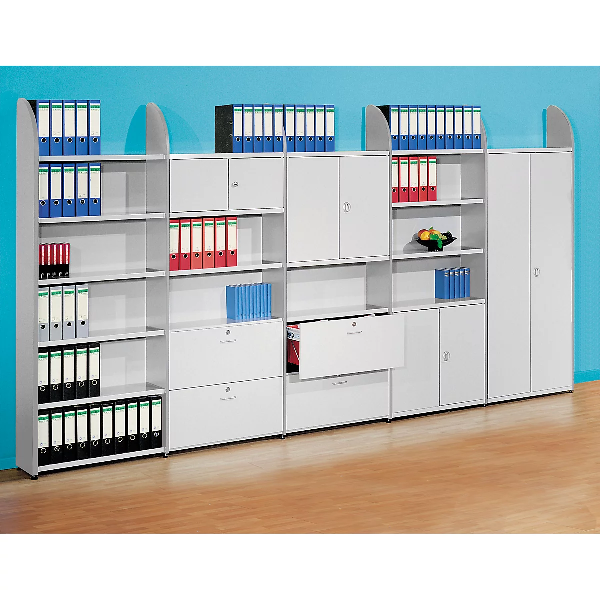 White office furniture with open shelves, cabinets and drawers filled with files. On a blue background.