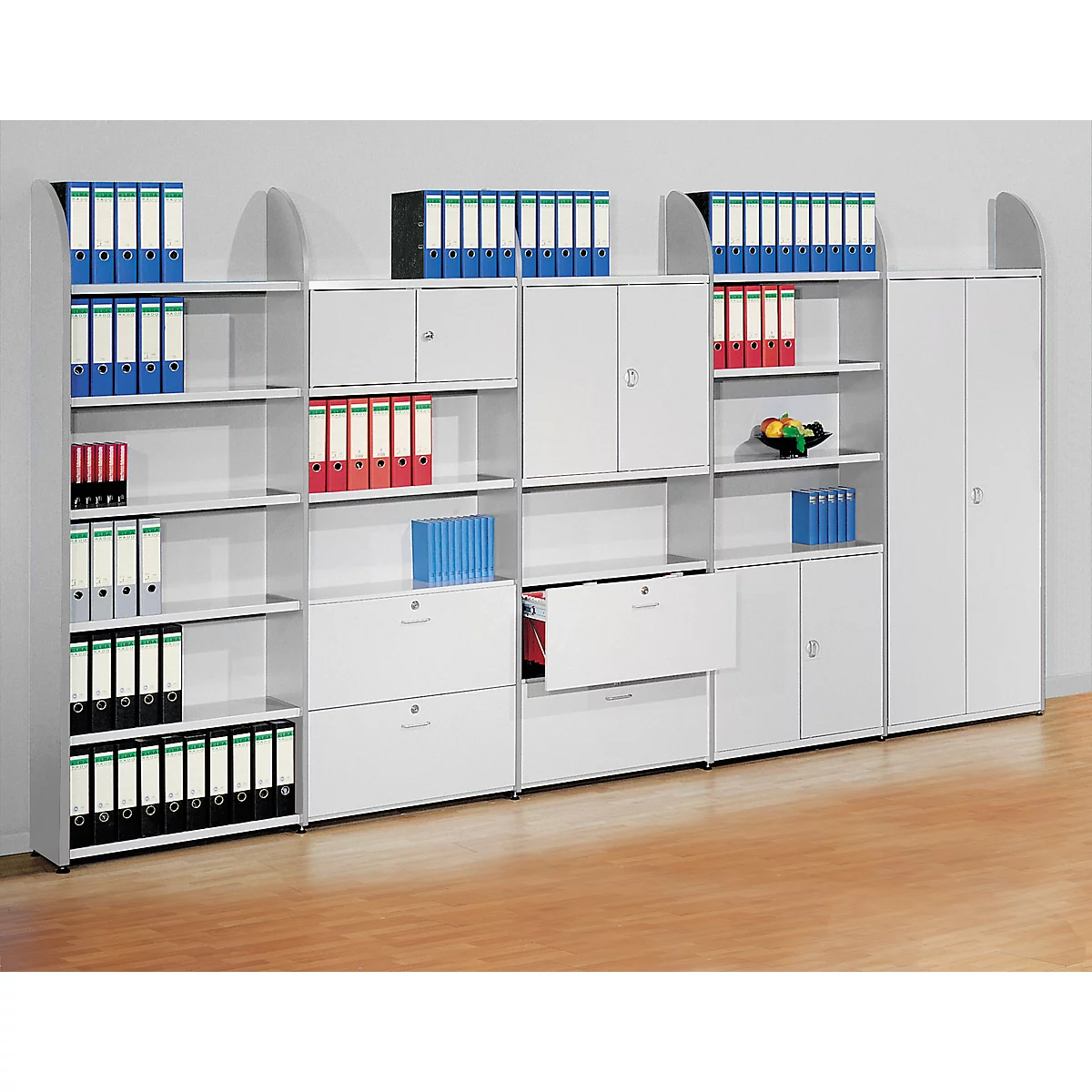 White office furniture with folders, drawers and cabinets. Some folders are color-coded.
