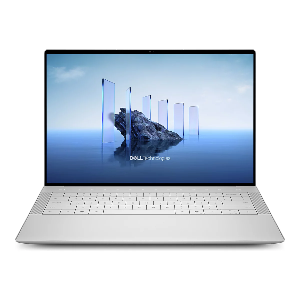 Ein silberner Laptop ist geöffnet, das Display zeigt eine blaue Landschaft mit blauen Säulen und einem Felsen. Der Text "Dell Technologies" ist zu sehen.