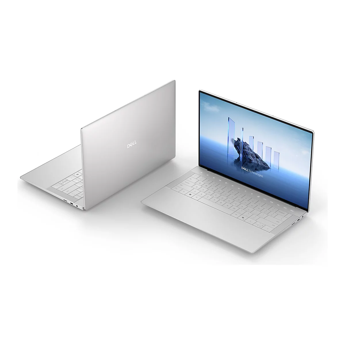 Zwei silberne Laptops, einer geöffnet, einer geschlossen. Geöffnet: Bildschirm mit Landschaft und Text, Tastatur sichtbar. Auf dem Deckel „DELL“.