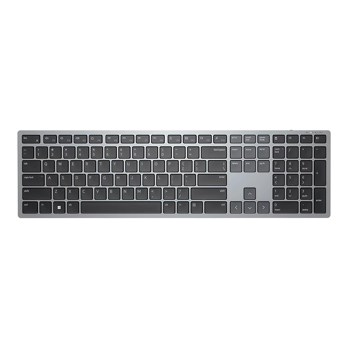 Vue de dessus d'un clavier argenté avec des touches noires, placé sur un fond blanc.