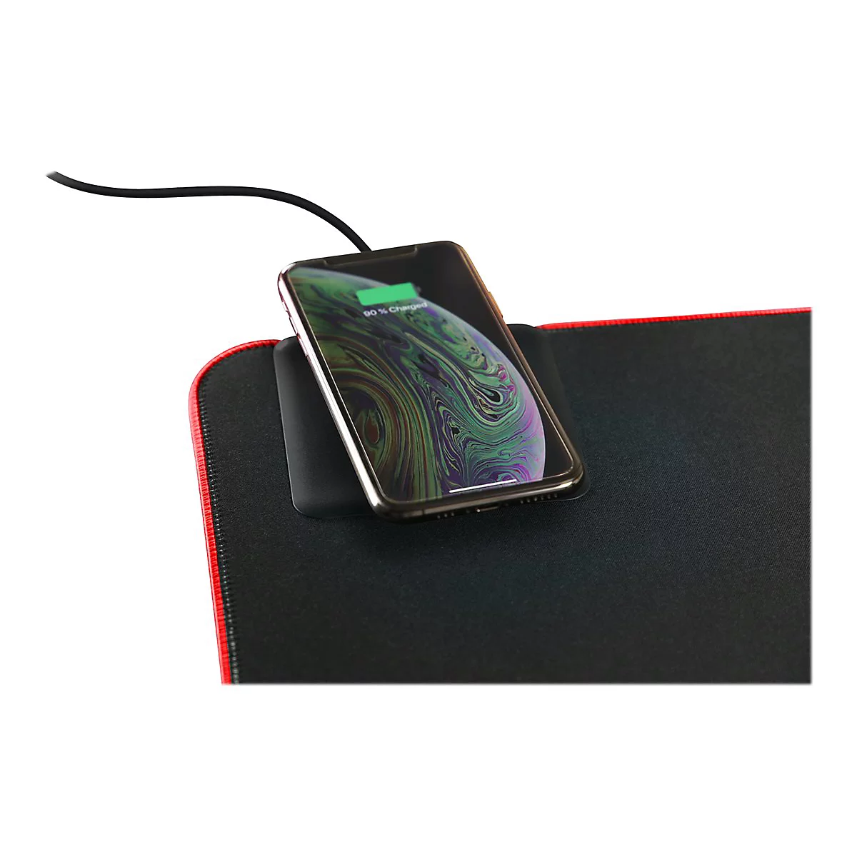 Ein Smartphone lädt kabellos auf einem schwarzen Gaming-Mauspad mit rotem Rand.