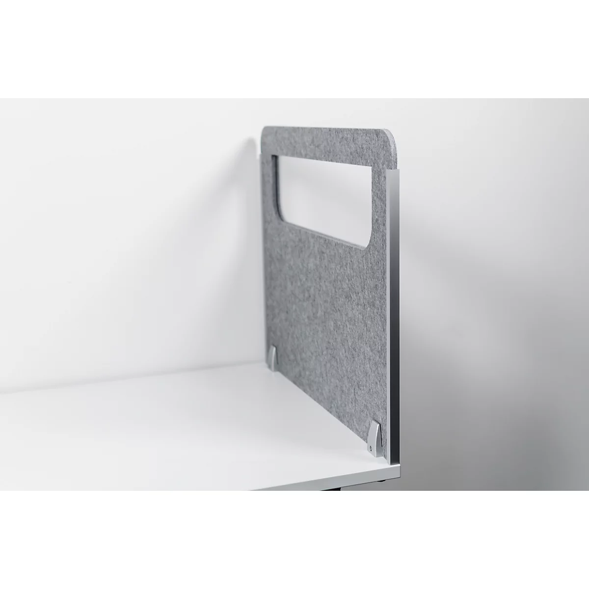 Gray felt desk partition with handle cutout, standing on a white table top.