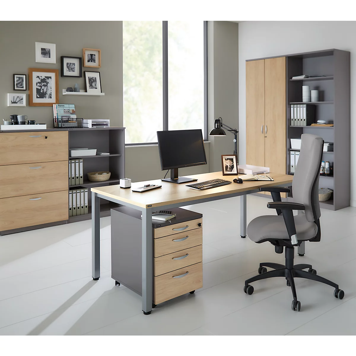 A modern office space with desk, cabinet wall, and chair, arranged in a bright, friendly atmosphere.