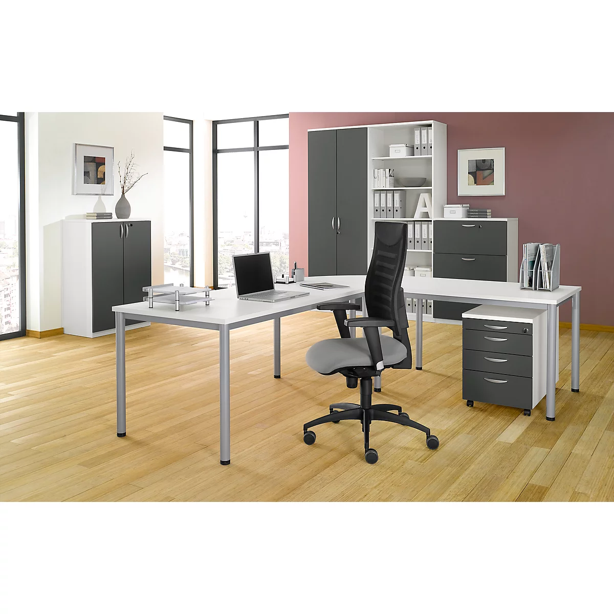 A modern office with desk, office chair, filing cabinet and laptop. Color scheme: gray, white, and pink.