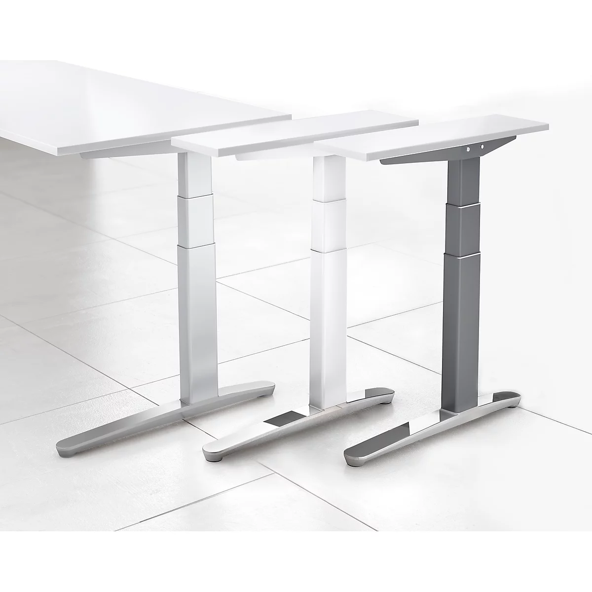 Three height-adjustable desks with different leg and tabletop colors, against a light background.