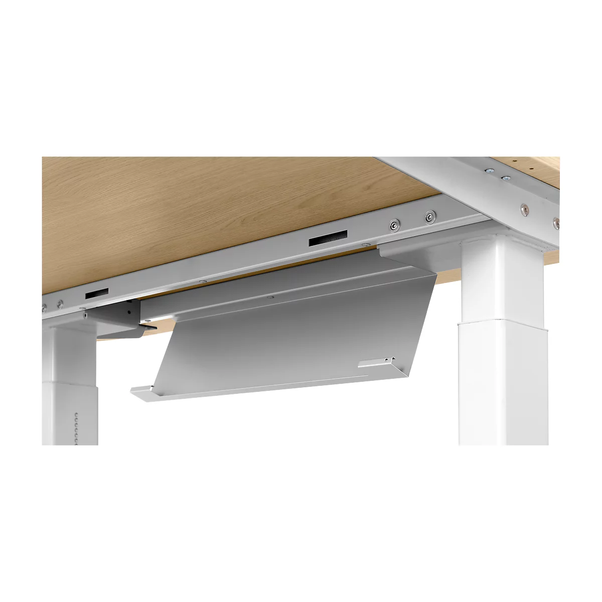 Close-up of the underside of a desk. A silver cable tray is mounted under the wooden top. The metal construction shows screws.