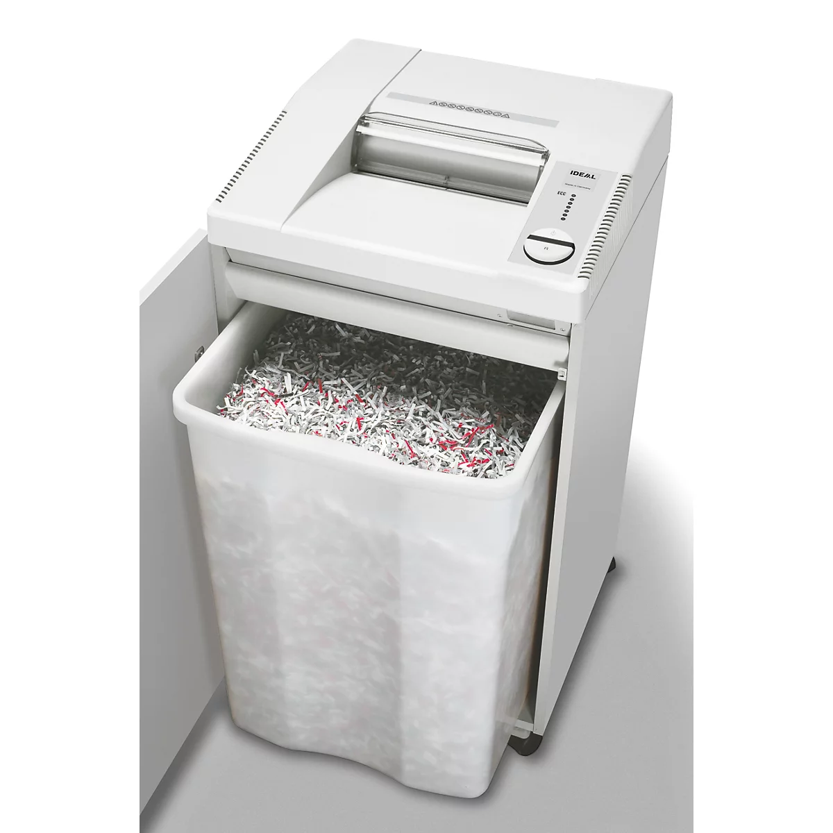 Déchiqueteuse blanche. Le bac de collecte est rempli de papier déchiqueté.