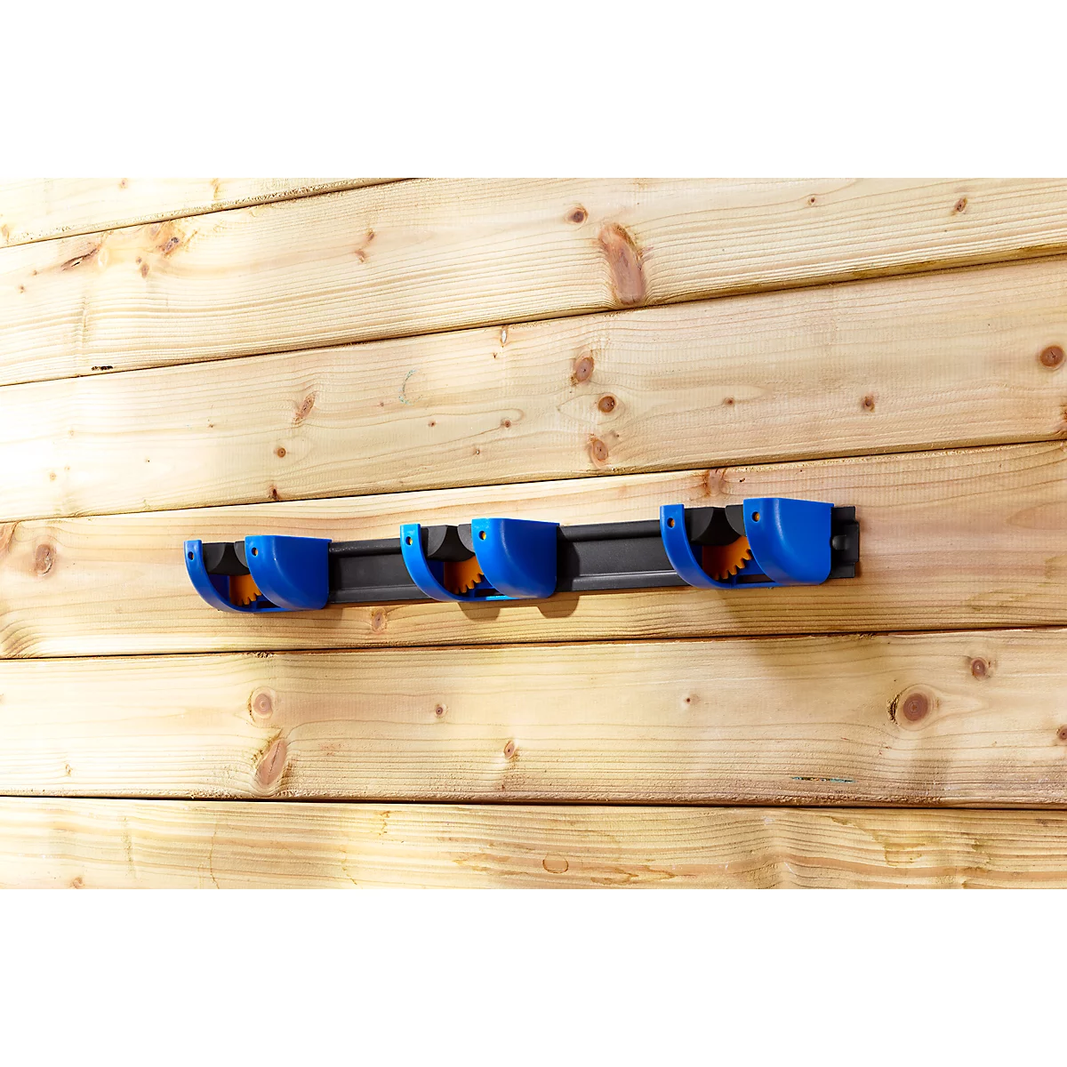 Blue tool holder mounted on a wooden slat wall.