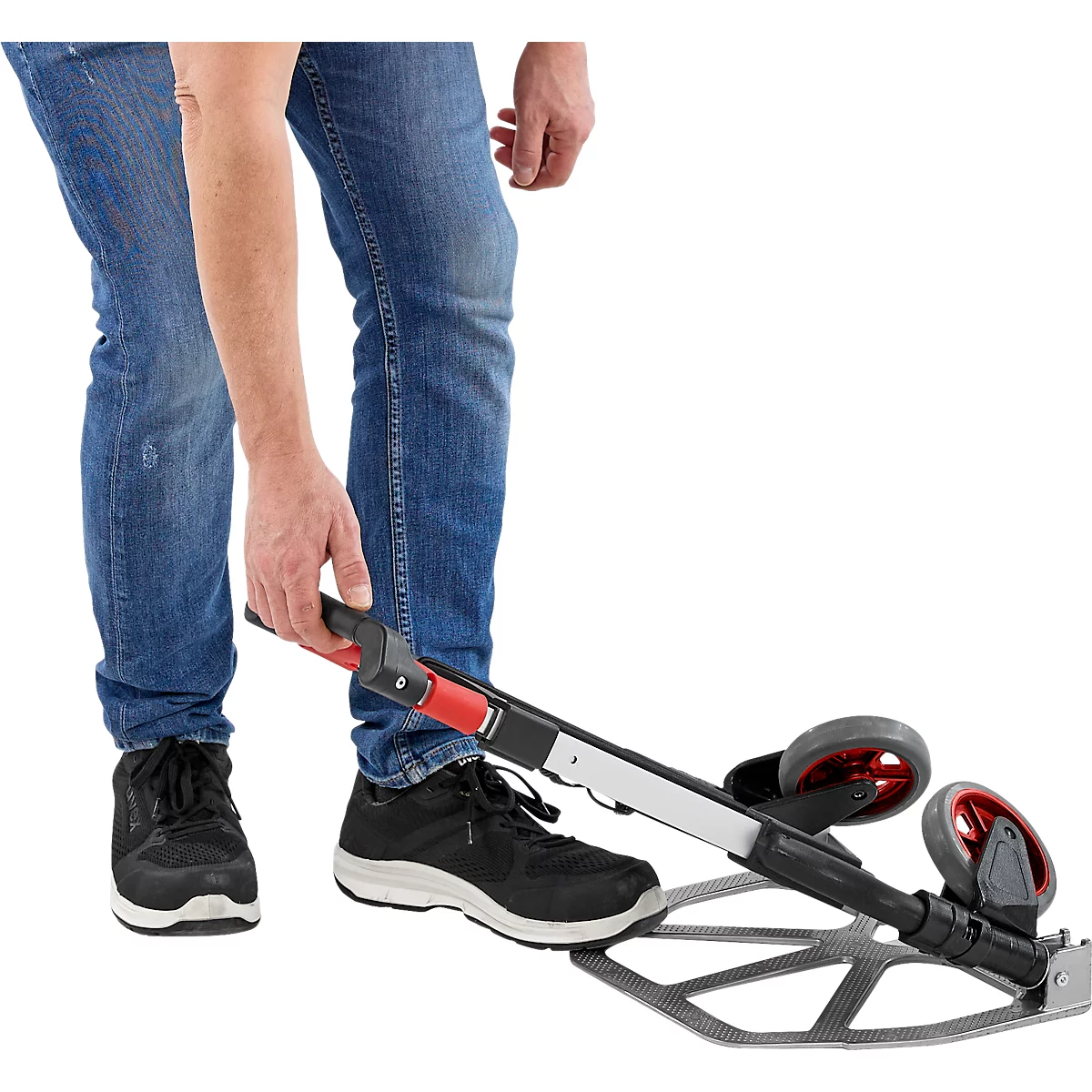 Personne en jean bleu actionne un appareil de mesure à roulettes.