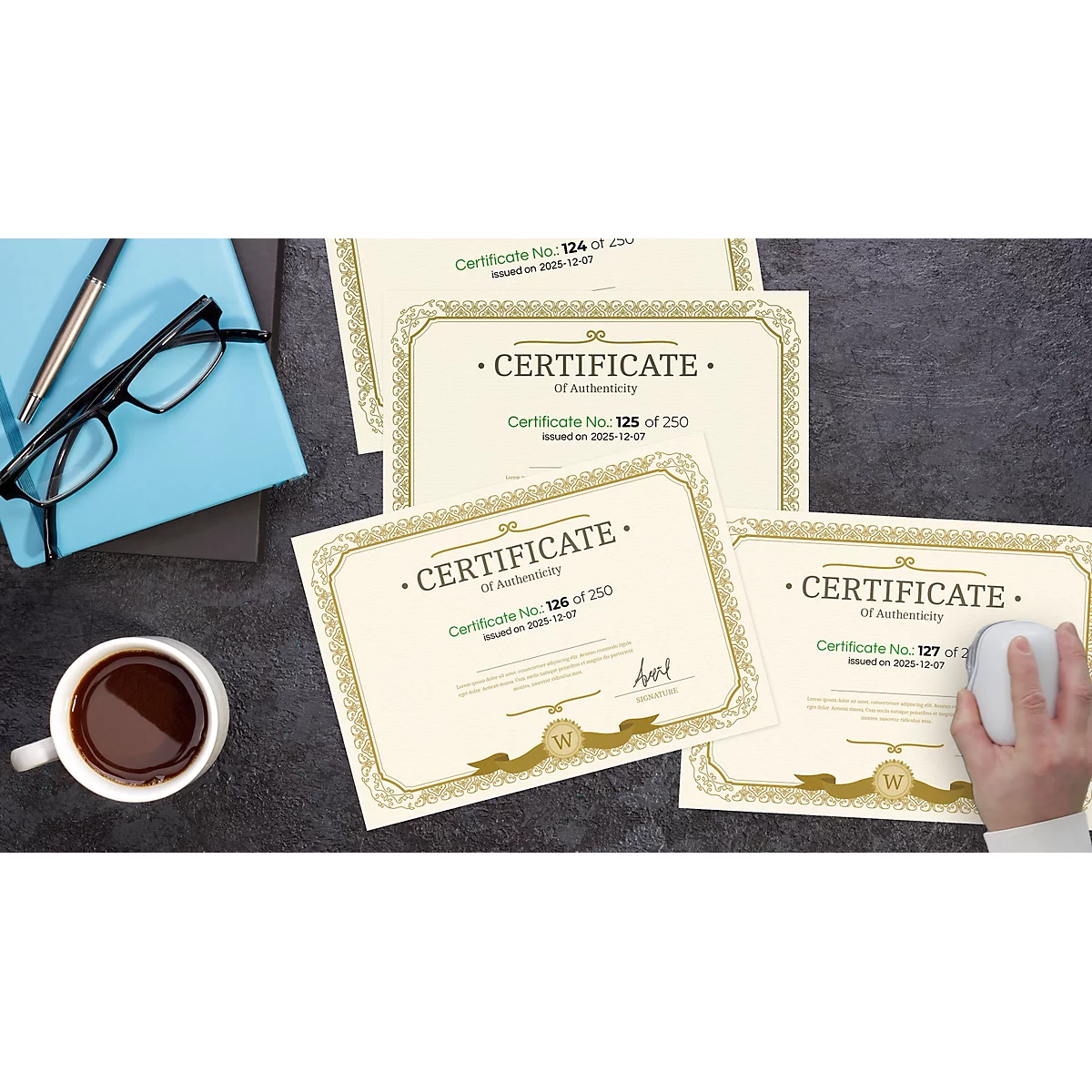 Overhead shot of a desk with certificates, a coffee cup, eyeglasses, a mouse, and a notebook.