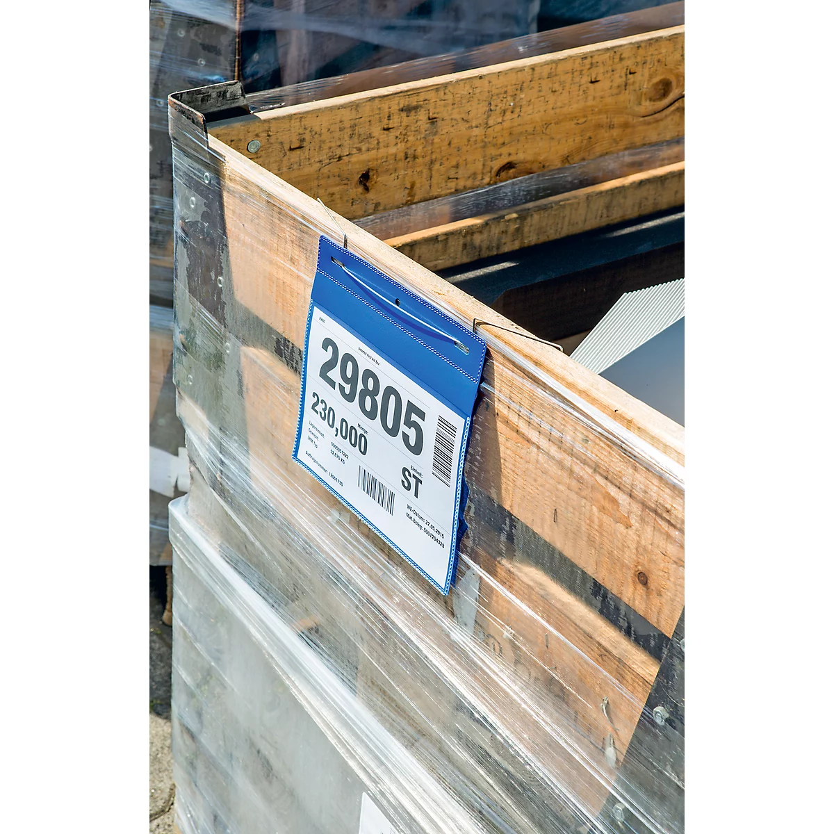 A label with the numbers 29805, 230,000, and a barcode on a wooden box wrapped in plastic.