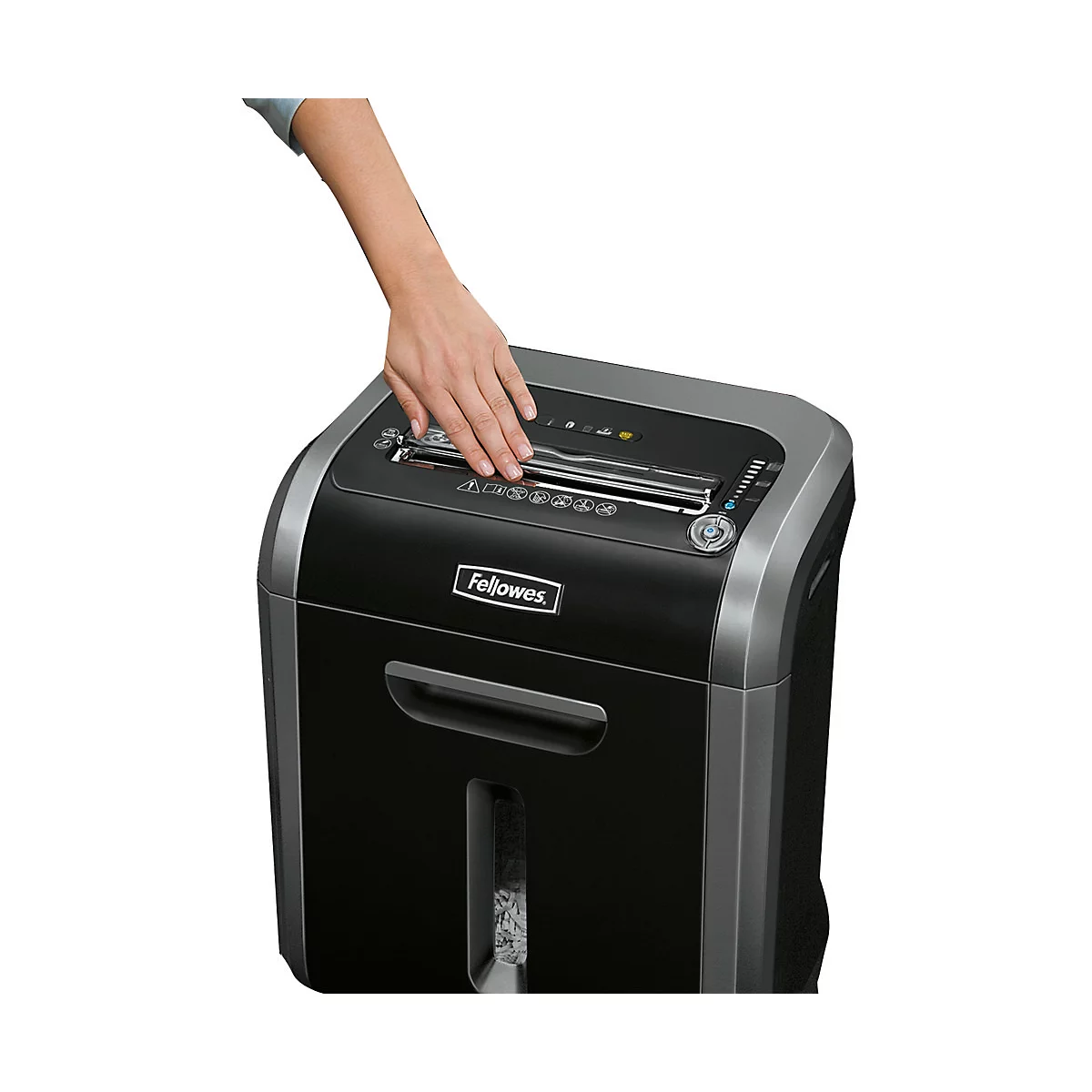 A person's hand resting on a black paper shredder. It says "Fellowes".
