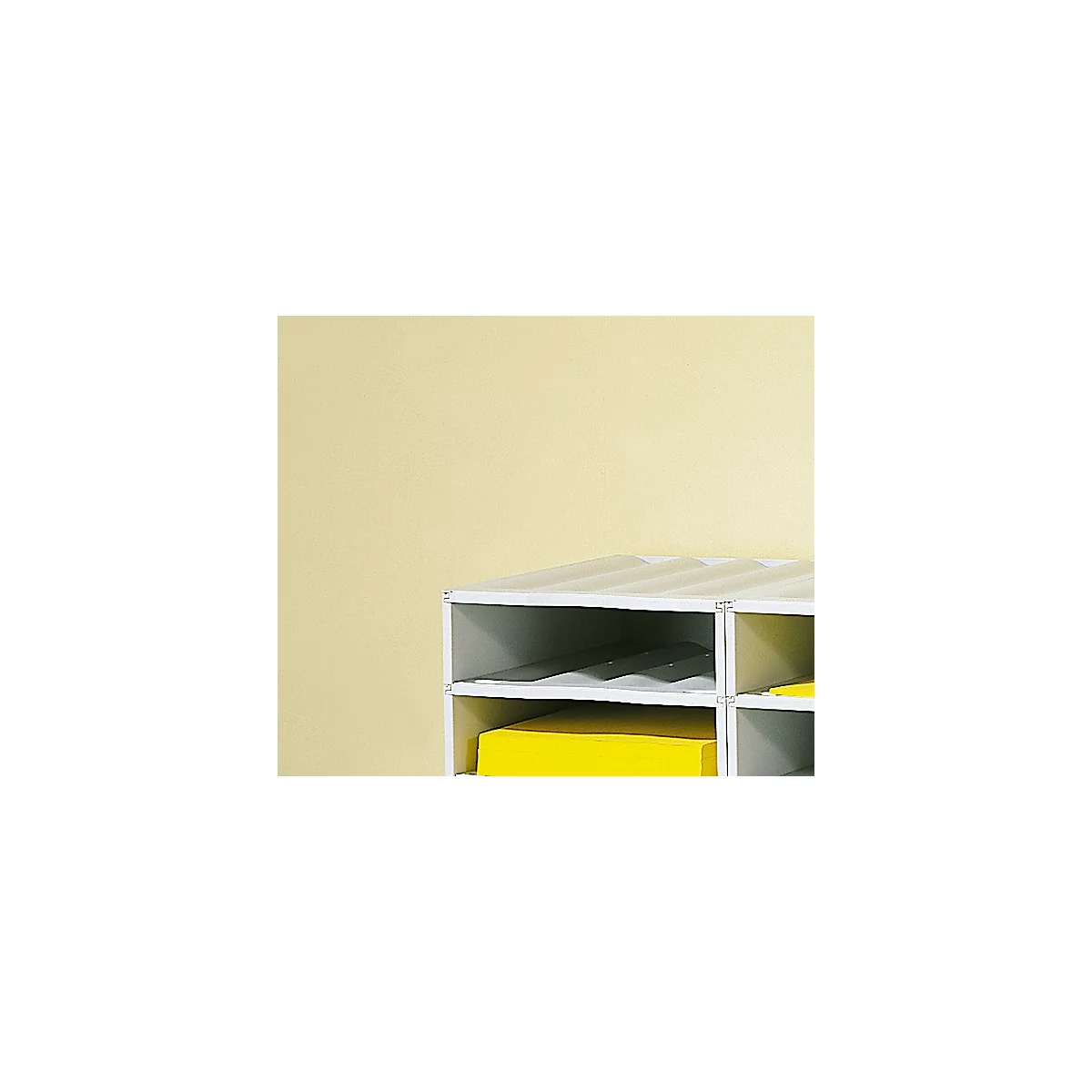 White open shelf on a light yellow background. There is a gray folder and a yellow folder in the compartments.