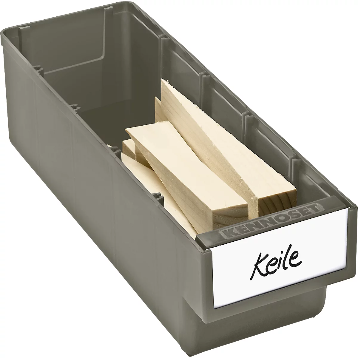 Gray plastic box containing wooden wedges. A handwritten sign reads "Keile".