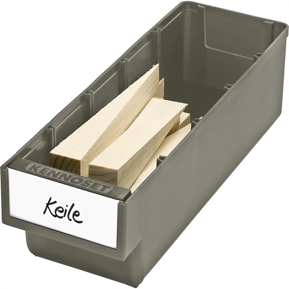 Grey plastic box with light wooden wedges, labeled with "Keile".