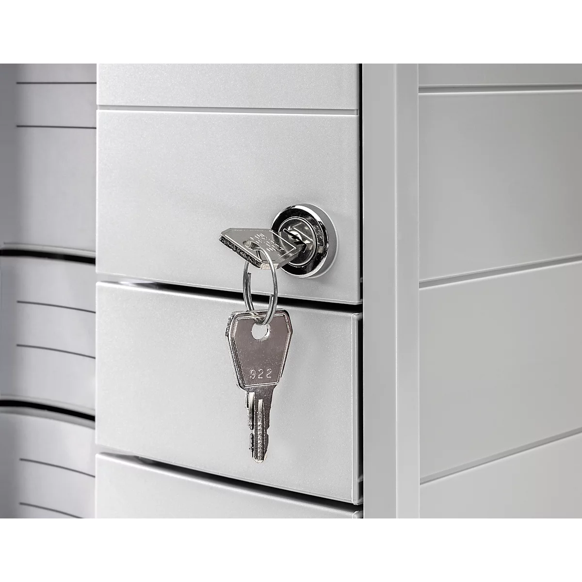 Key in the lock of a cabinet, gray metal doors, detail view.