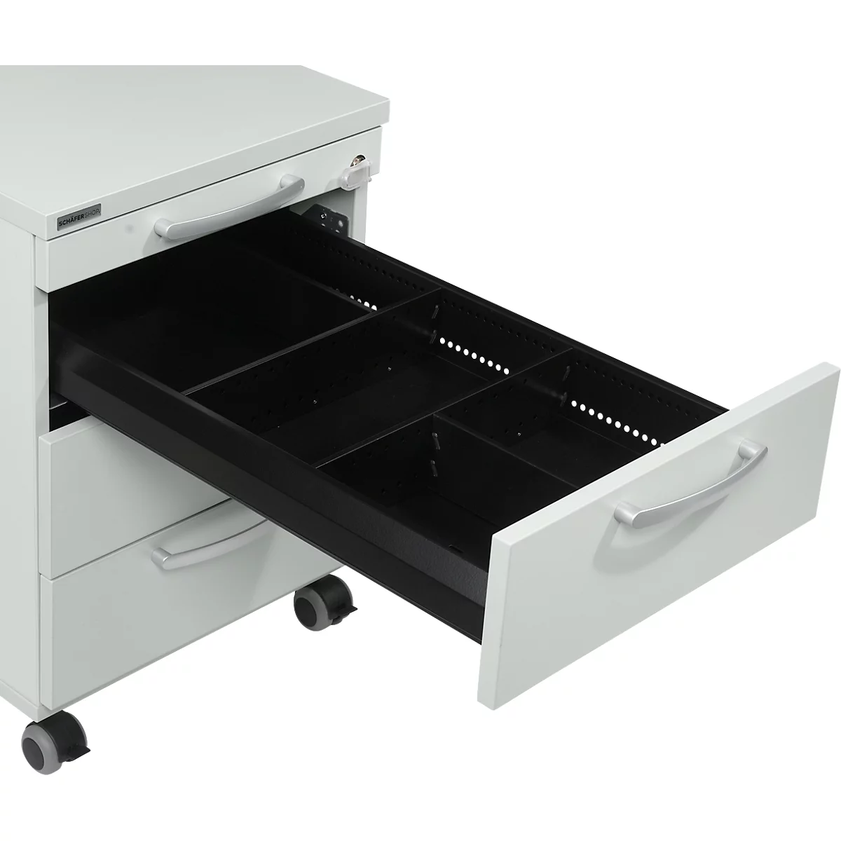 White filing cabinet with an open drawer. Black compartments divide the drawer.
