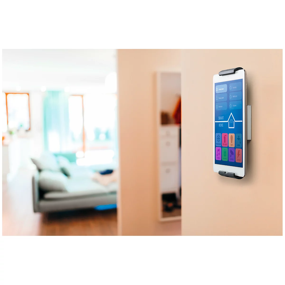 A smartphone mounted on the wall controls a smart home. Various options are displayed on the screen.