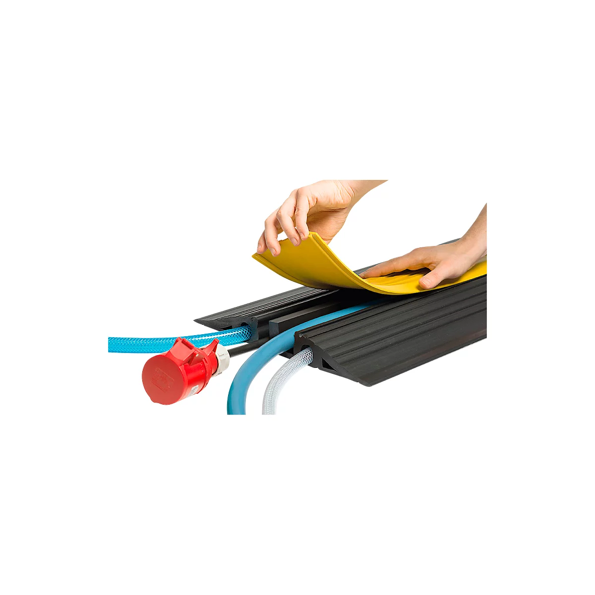 Person placing a yellow cover on a black cable bridge. Blue and white cables and a red plug are visible.