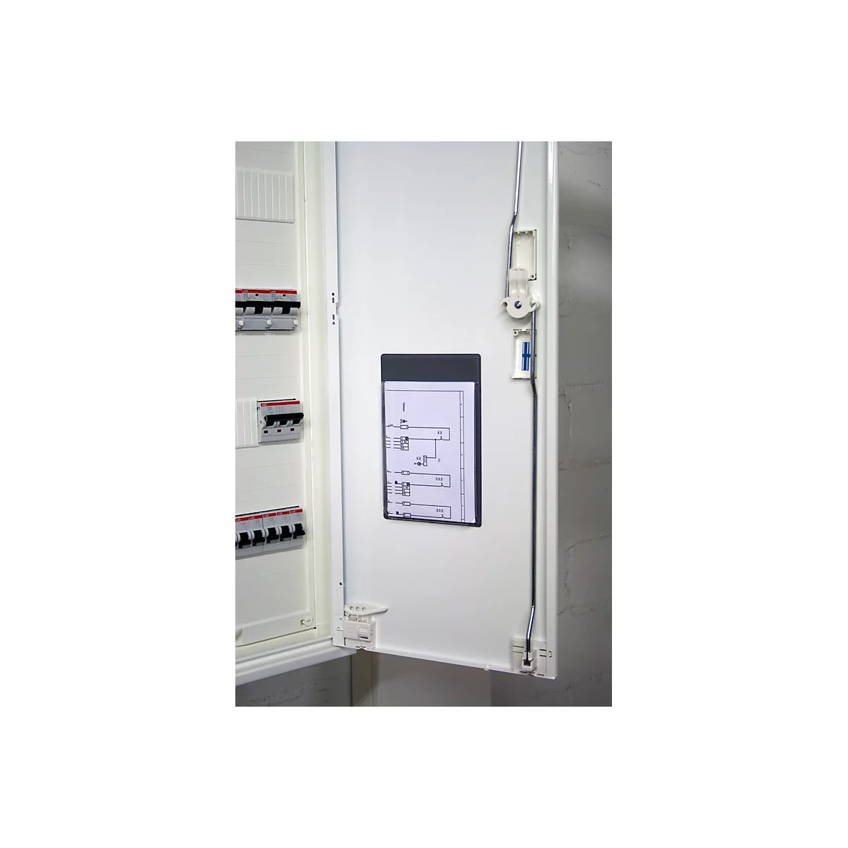 Open fuse box door, with wiring diagram and fuses, the door is white, the background light gray.