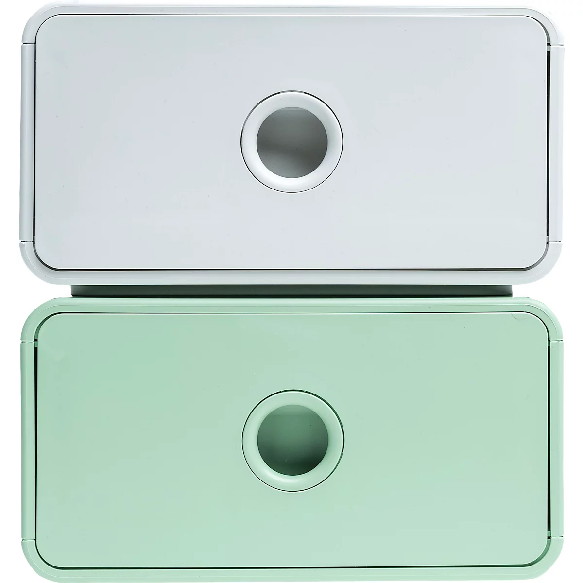 Deux boîtes de rangement empilables, blanches et vert menthe, avec des ouvertures circulaires au centre.