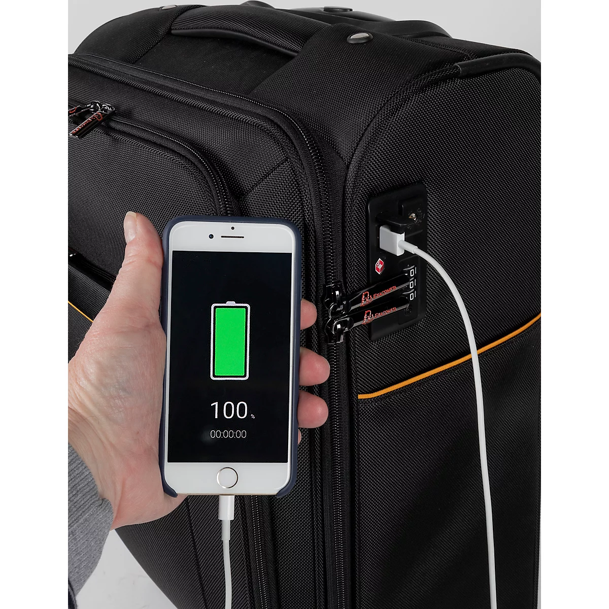 Schwarzer Koffer lädt Smartphone mit 100% Akku. Kabel zum USB-Anschluss. Oranger Streifen am Koffer.