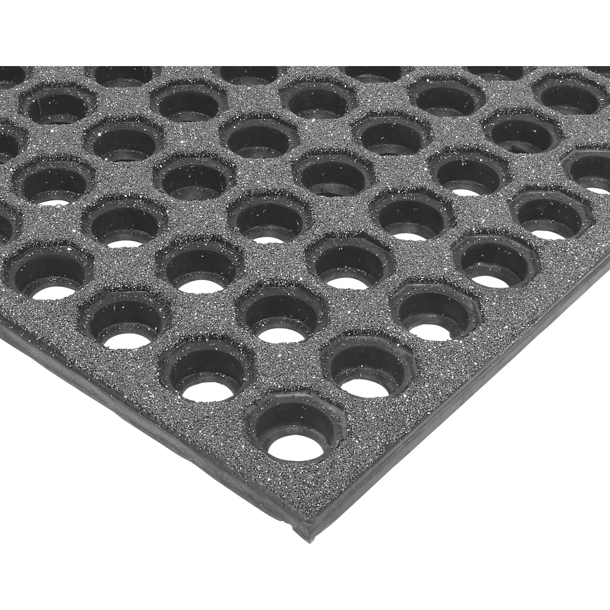 Close-up of a black rubber floor mat with hexagonal holes.