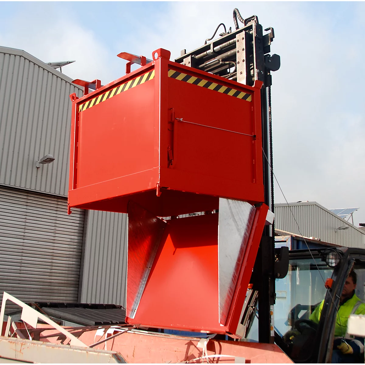 Red container on a forklift. The container has black and yellow warning stripes.