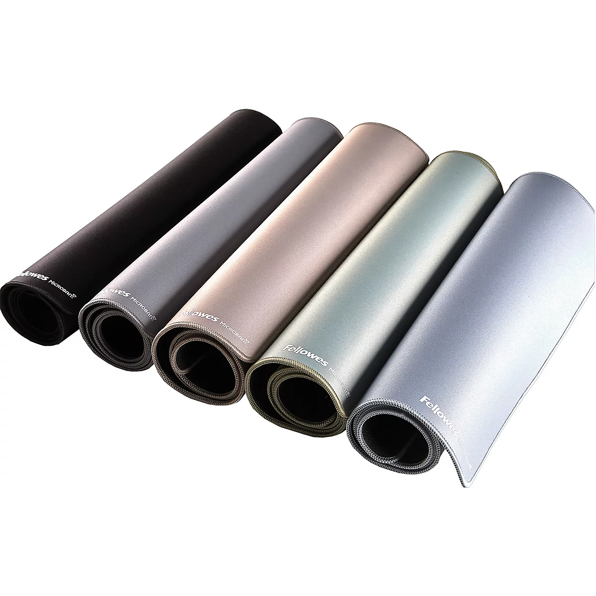 Six rolled desk mats in various colors, from black to silver, are lying side by side.