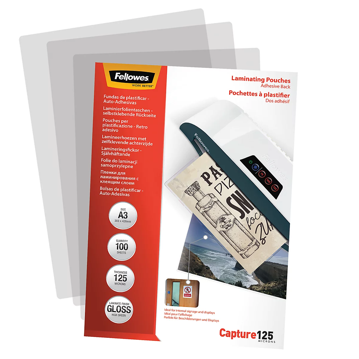 A pack of laminated plastic sheets, next to a laminator and a laminated picture.