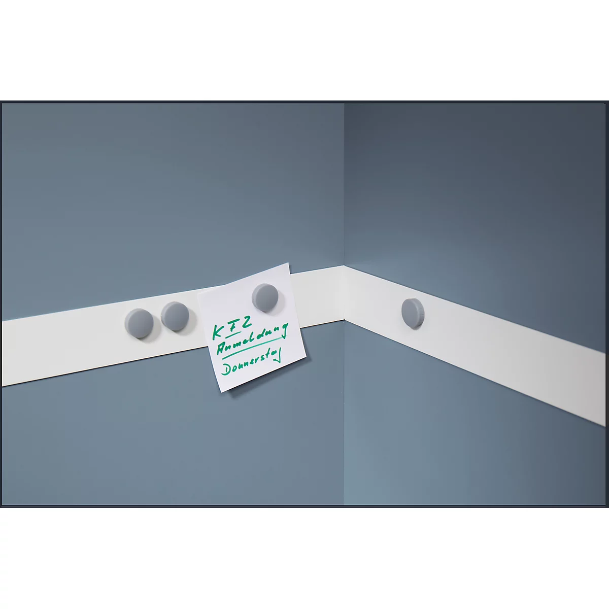 Corner with white tape, with a note attached by gray magnets. Note: KTZ Remodeling Thursday.