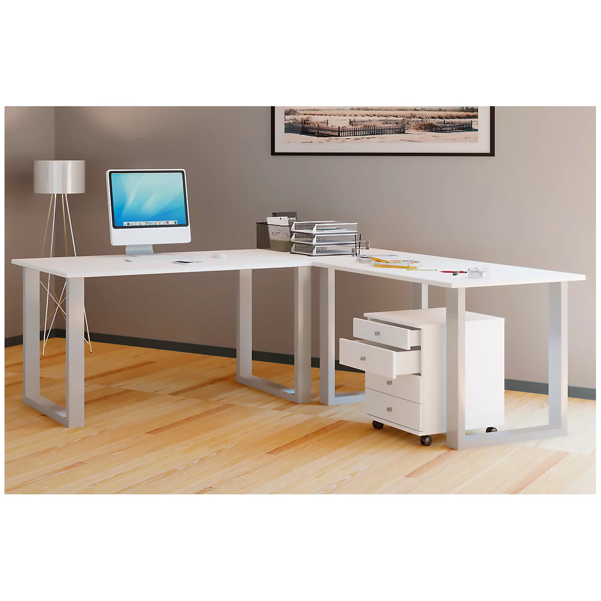 White corner desk with silver legs, computer, and drawer cabinet.