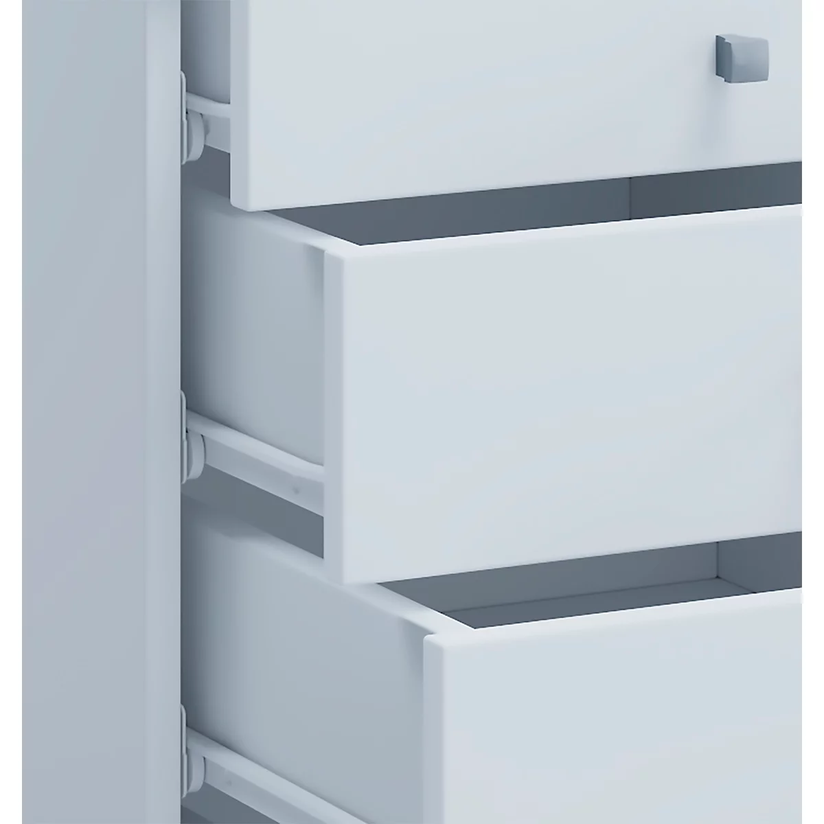 Detail of a white drawer partially open. Silver rails are visible.