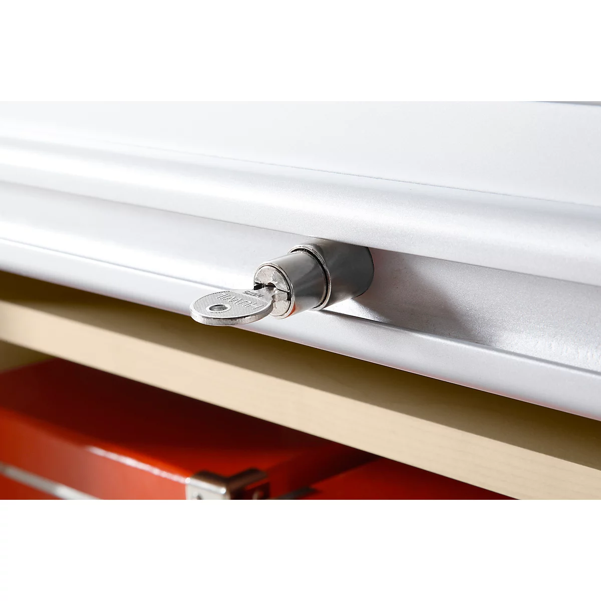 Close-up of a cabinet lock with key inserted.